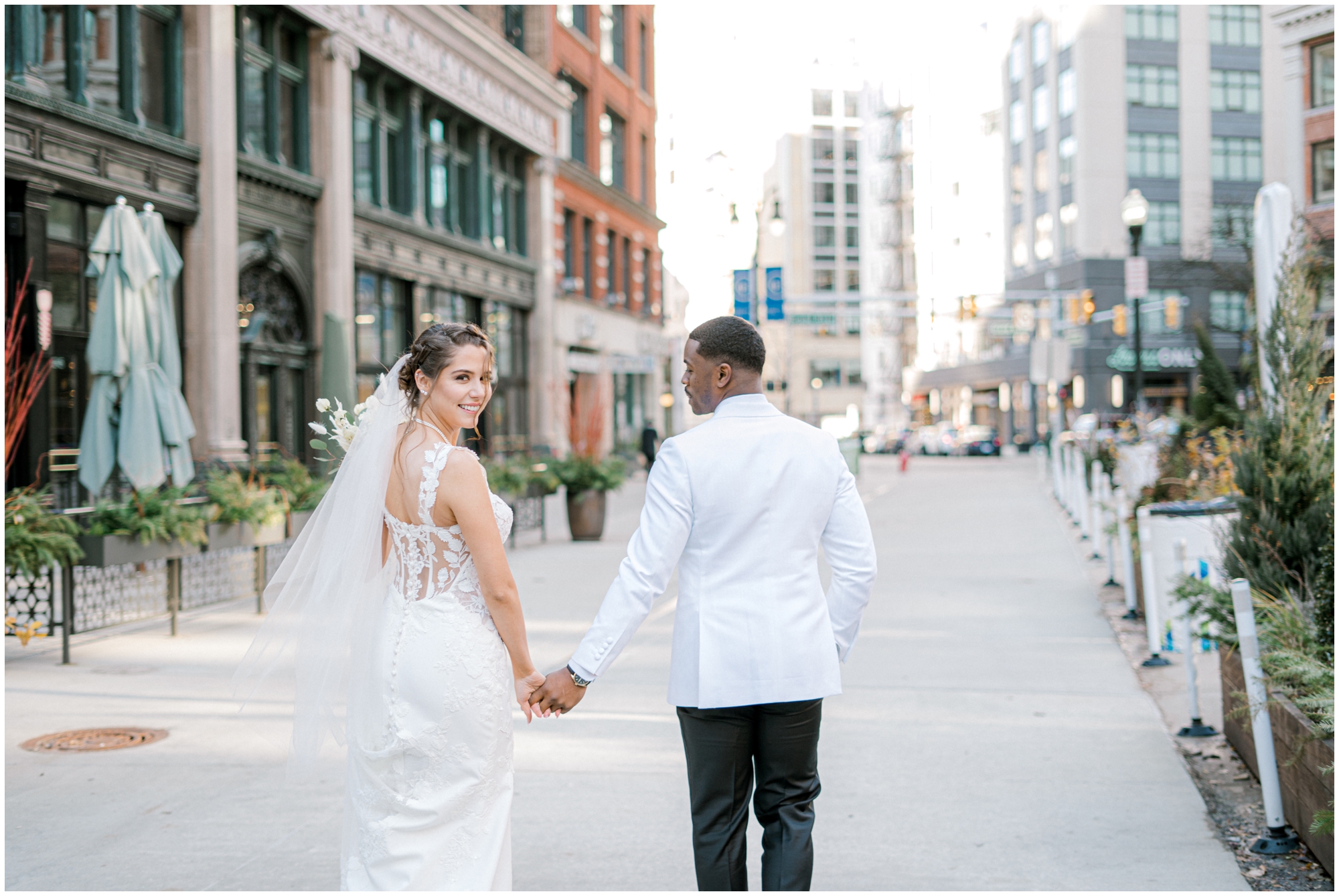 choosing a Detroit wedding photographer photo of bride and groom walking downtown