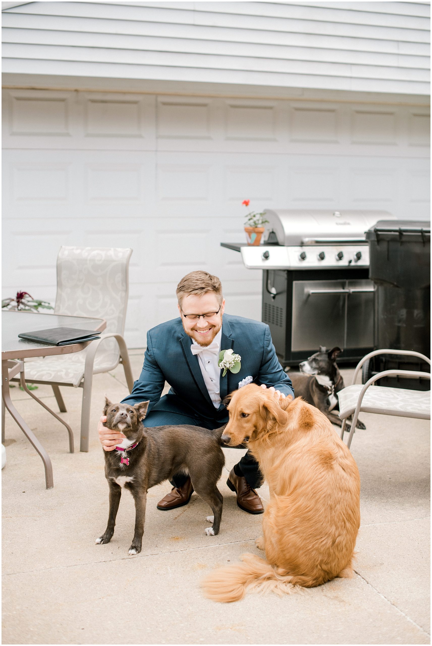 groom poses with dogs
