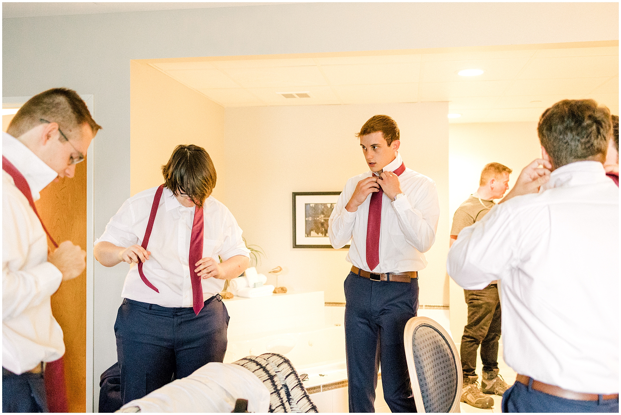 groom and groomsmen putting on ties