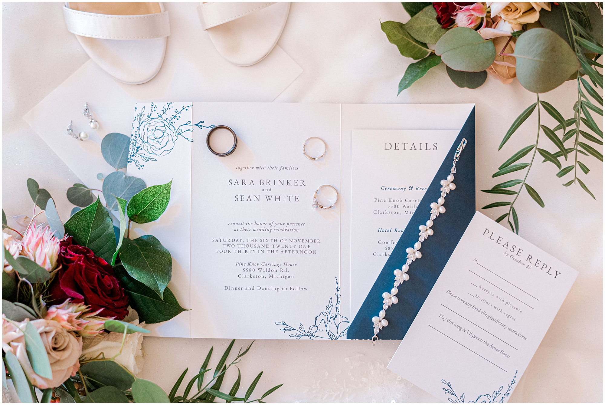 flat lay of wedding invitations, rings, and bridal shoes