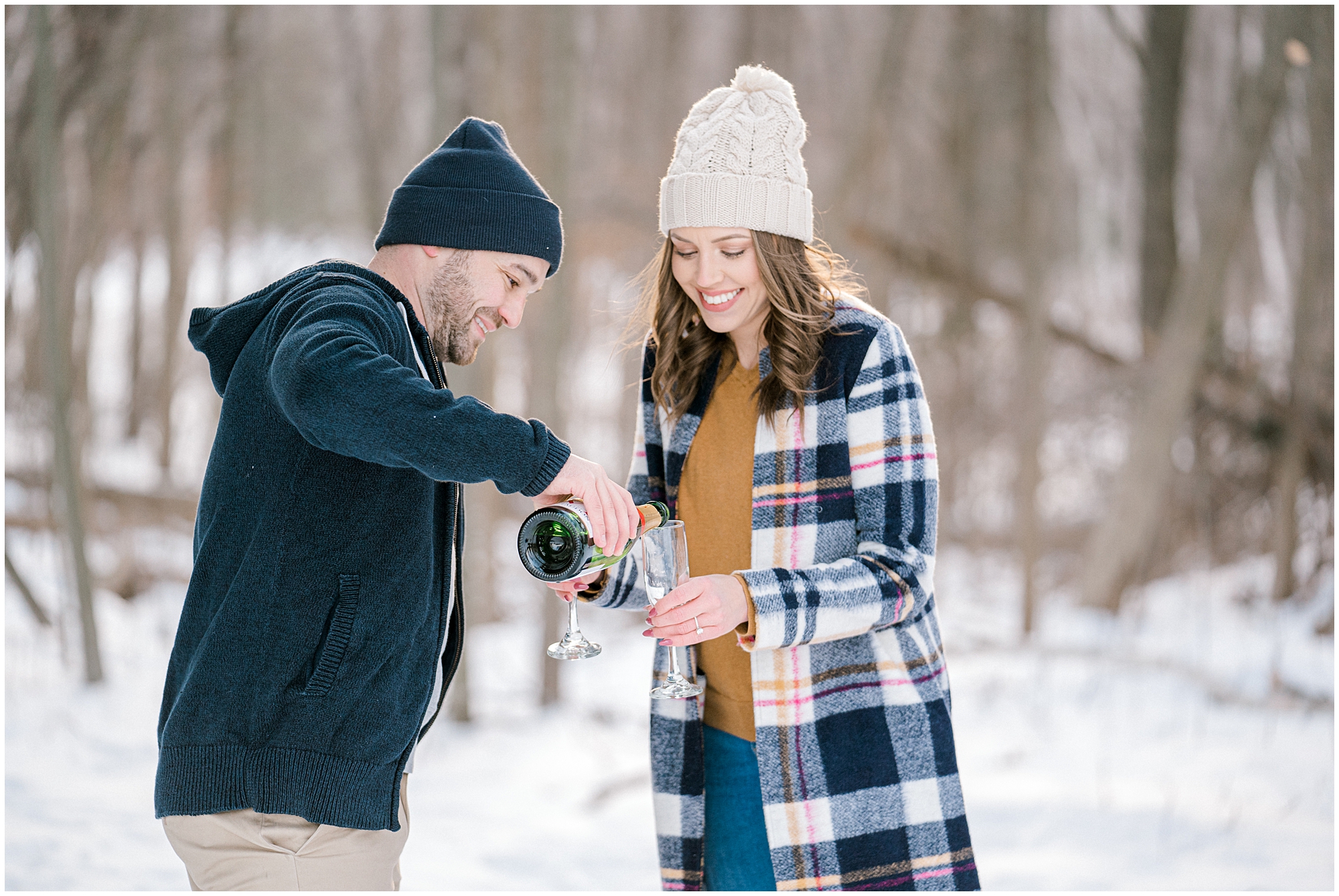 winter engagement photos with champagne pop