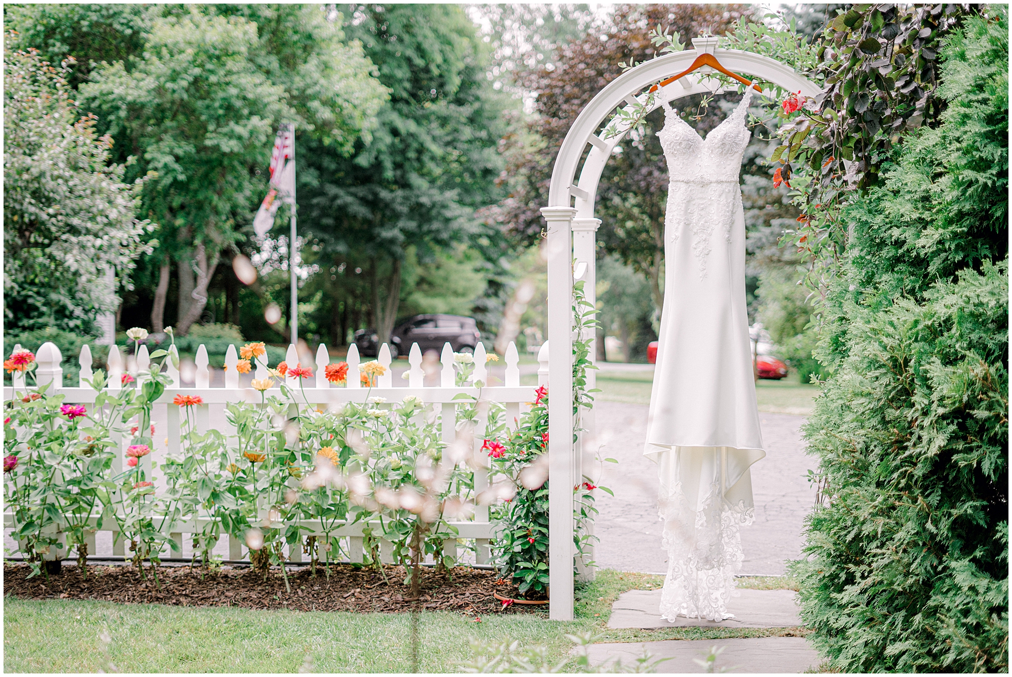 wedding dress hanging in garden wedding venue