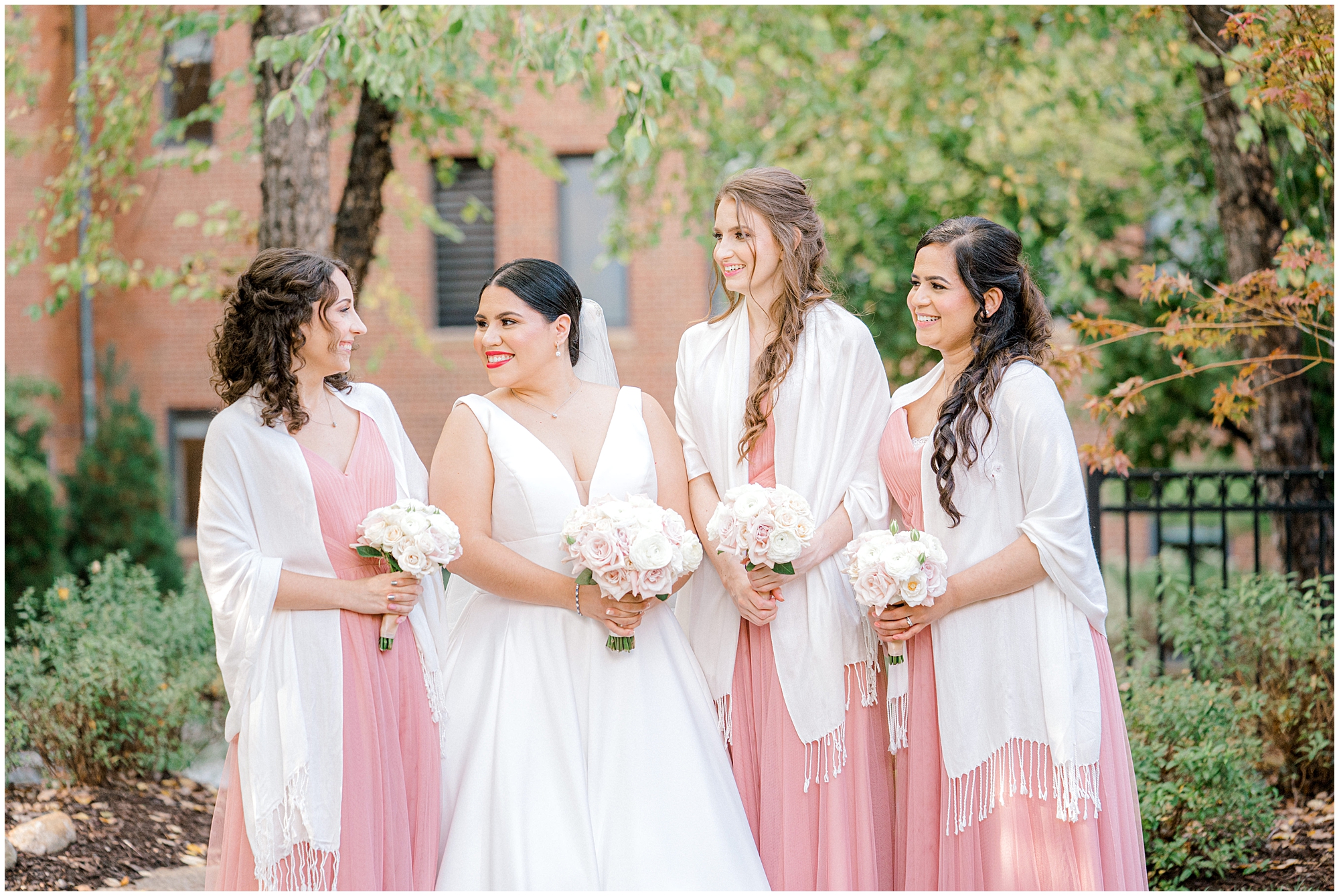 bridesmaids wearing white wraps to stay warm during fall wedding