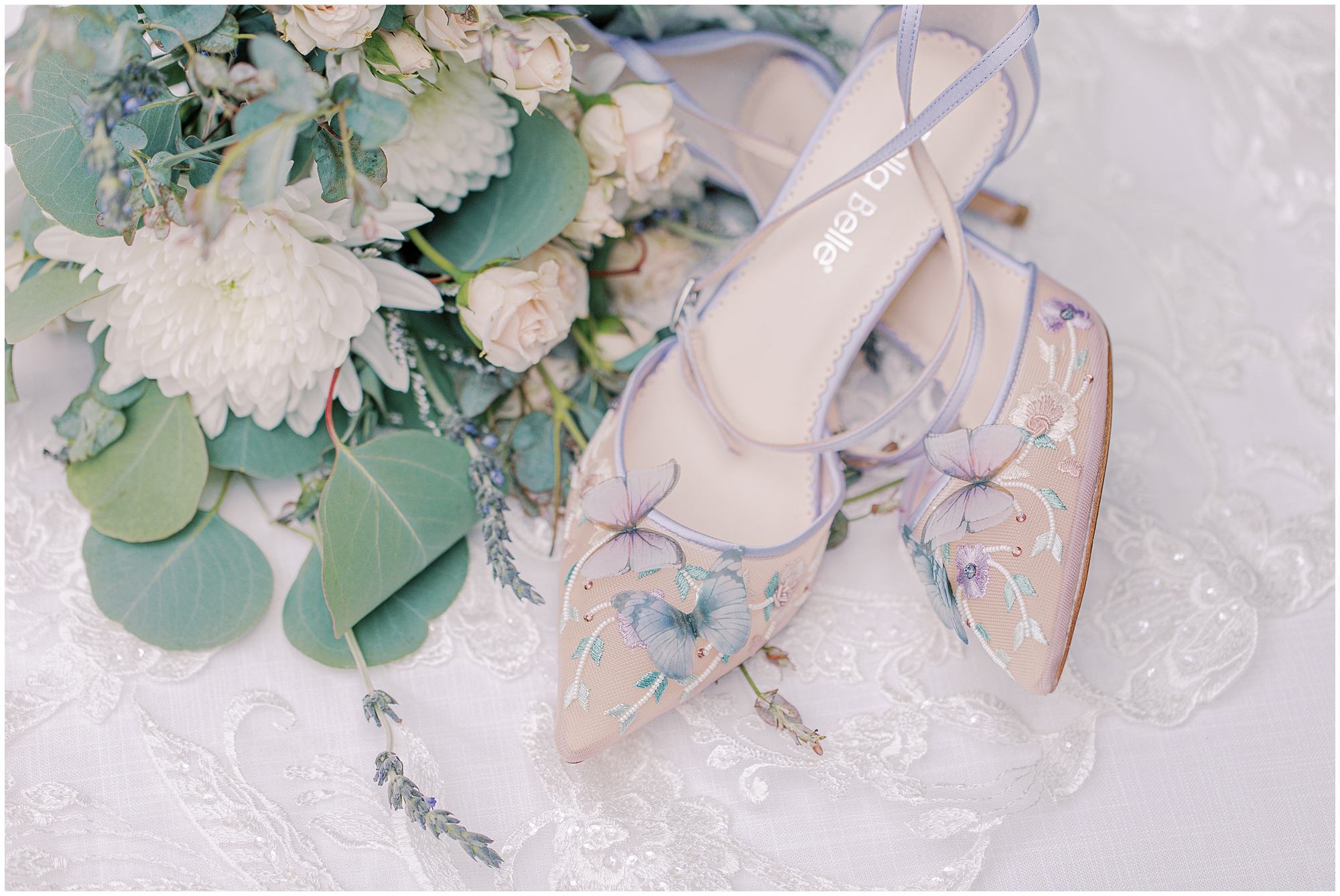flat lay of bridal shoes and bouquet