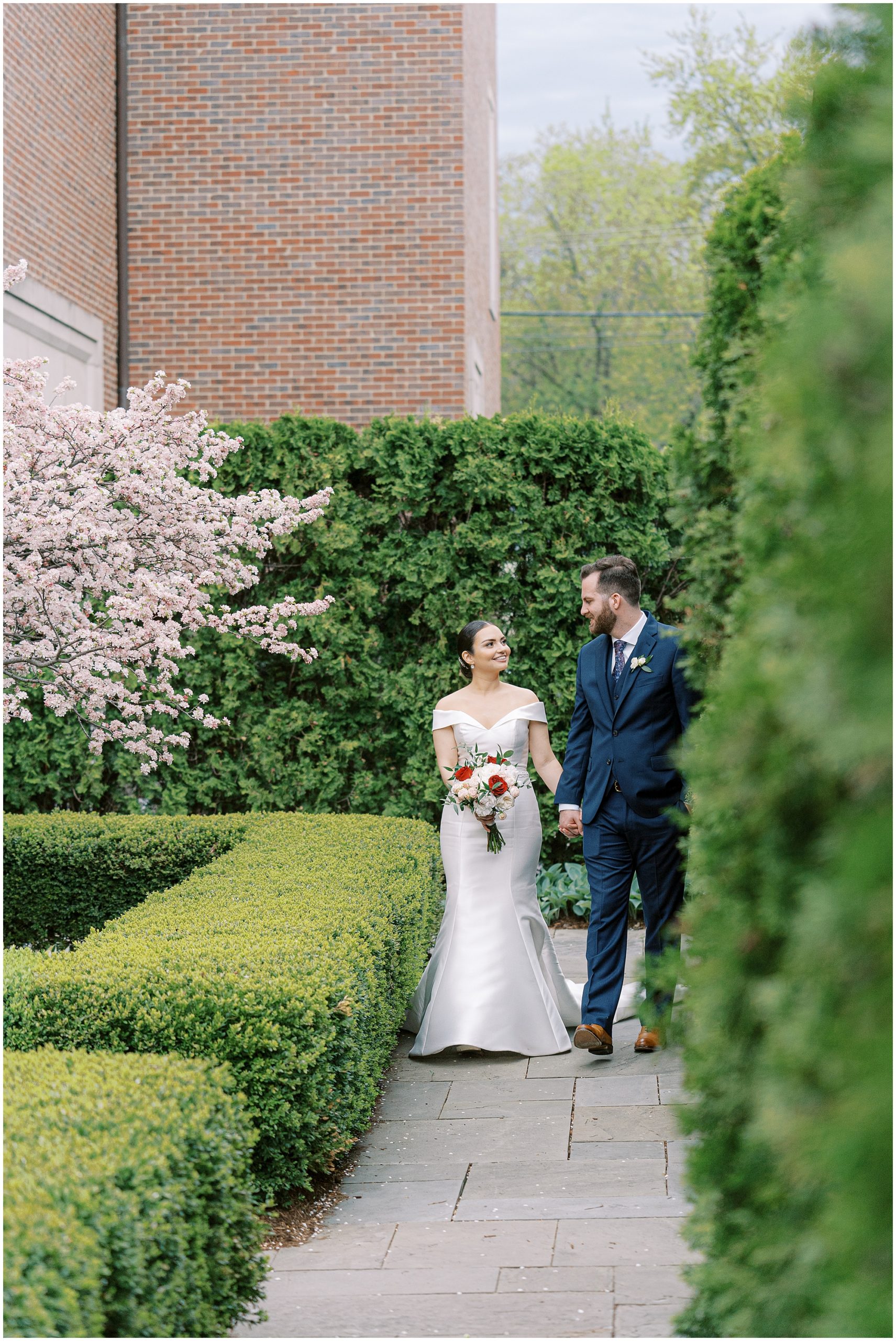 bride and groom walking in garden venue in Detroit
