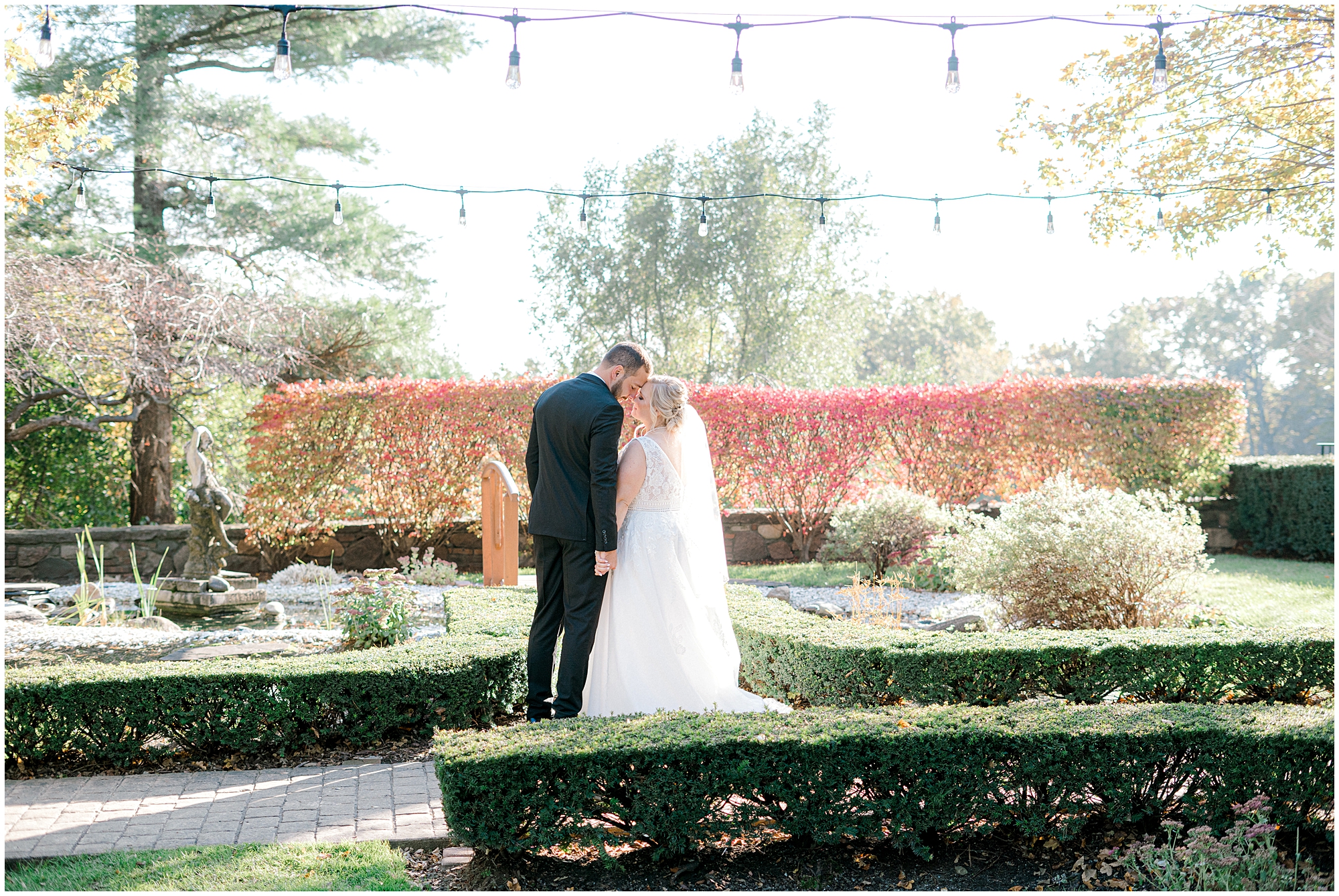 bride and groom kiss in Michigan at fall wedding