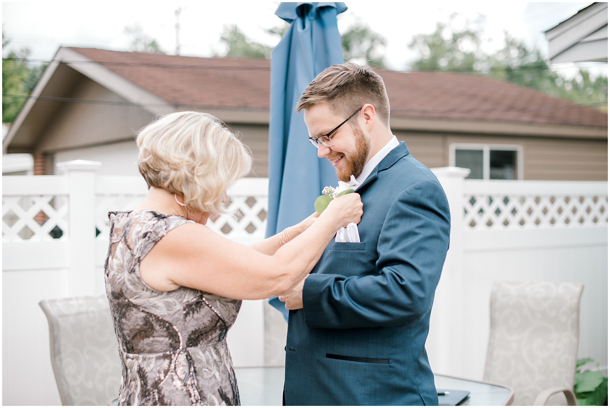grooms mother putting on boutonniere