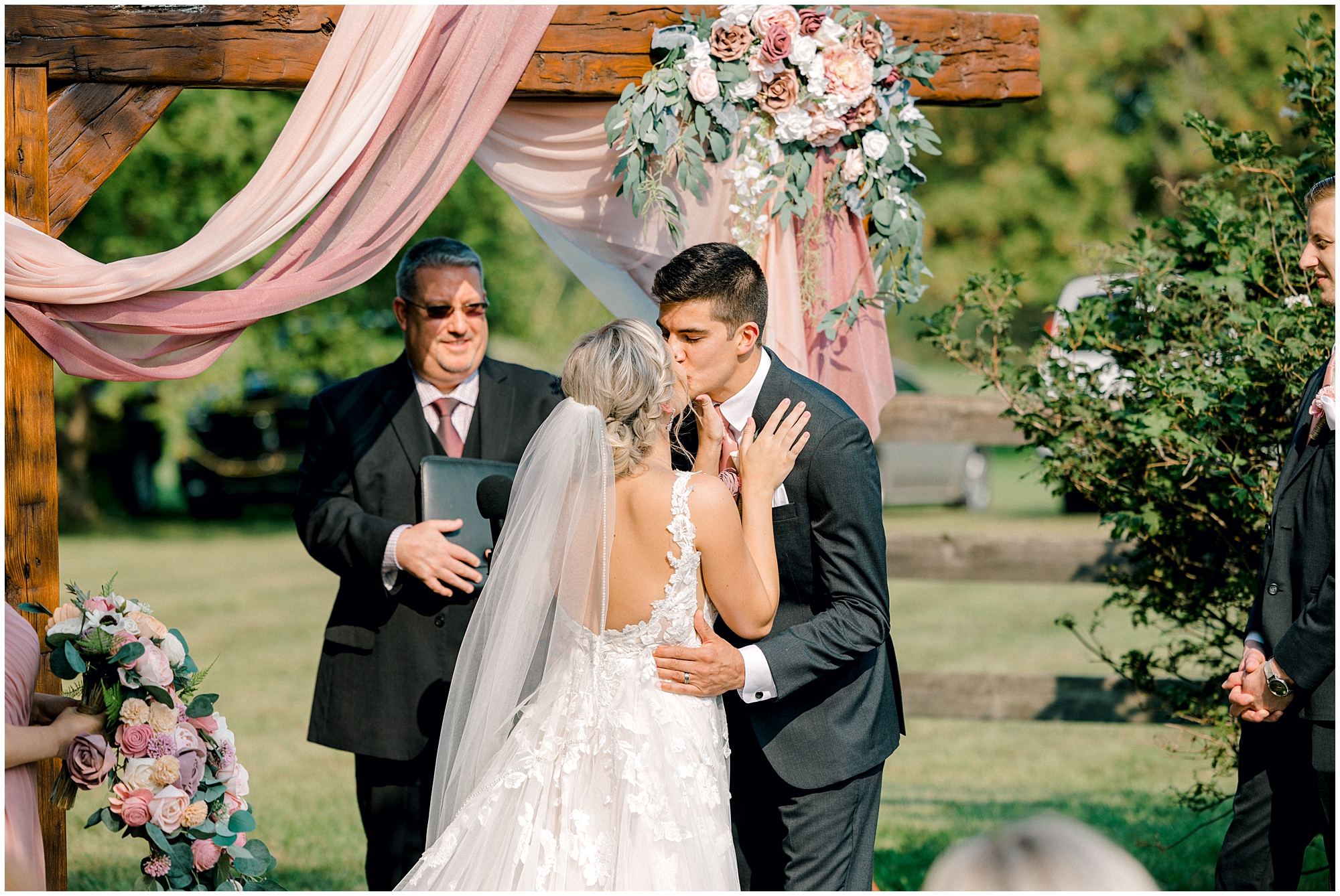 a different angle of your first kiss as an example of why to hire two wedding photographers