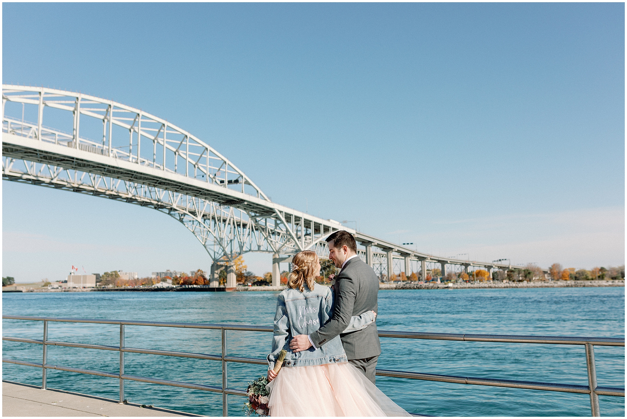 couple stands by water at destination wedding