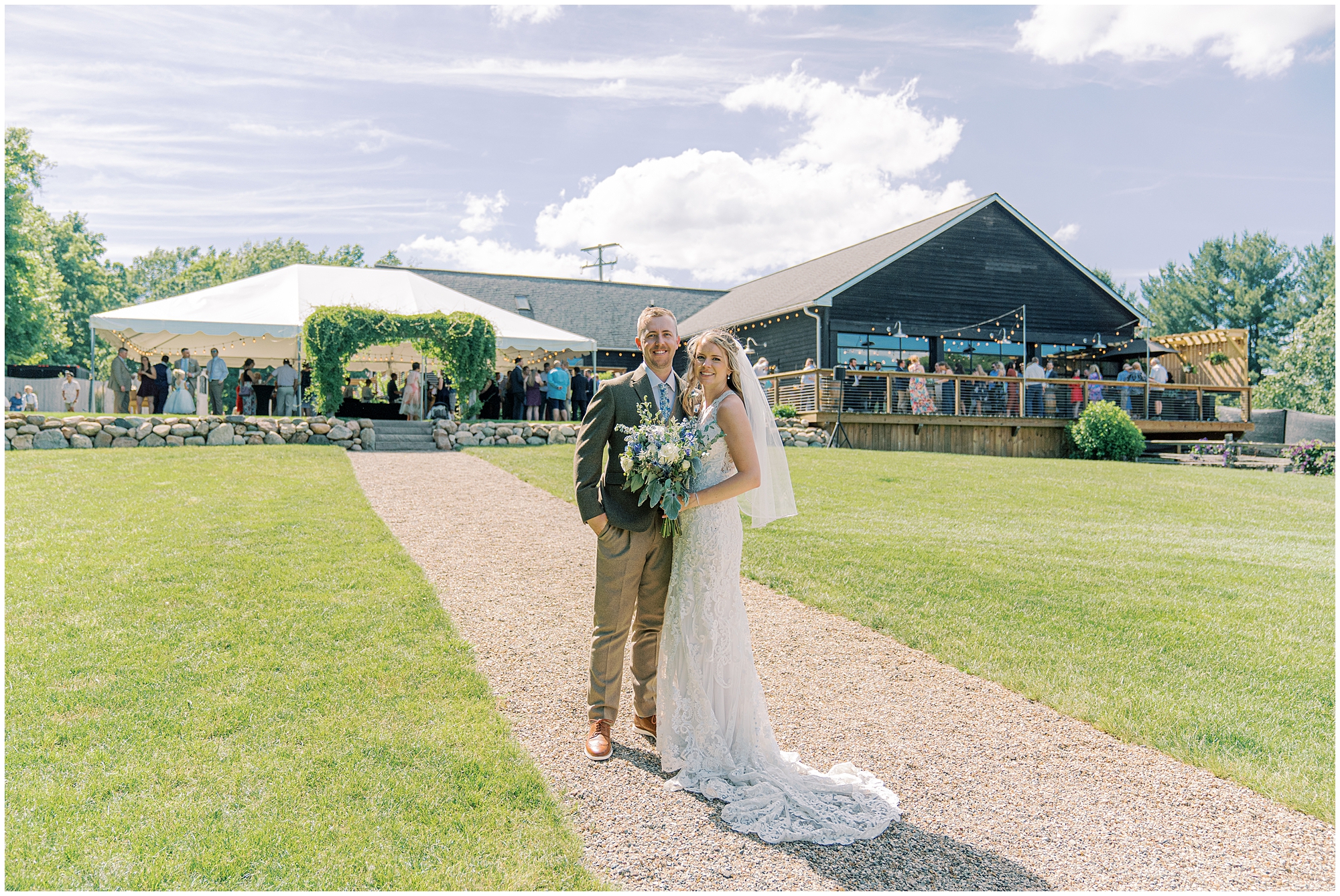 bride and groom pose outside wedding venue planned by Shoreline Event Design